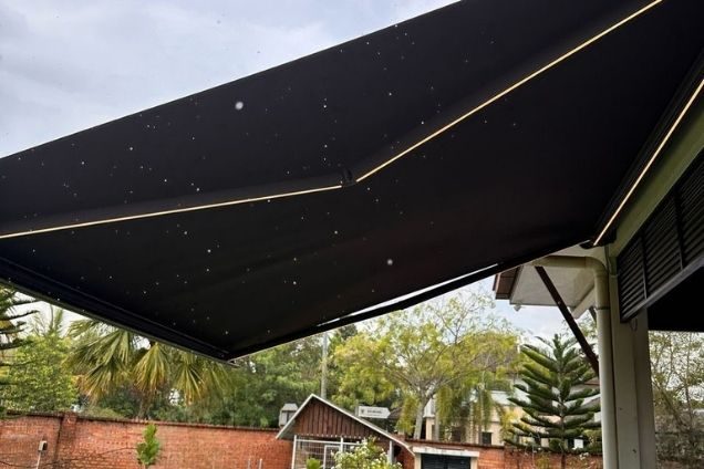 Black cassette awning extended over an outdoor area.